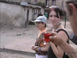 The family is offered a drink in the neighborhood where the Lodz Ghetto stood.